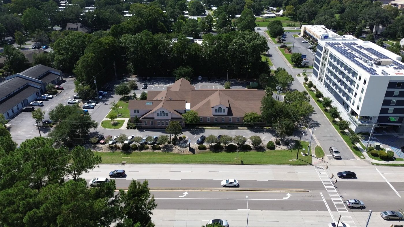 Wide aerial showing full property and adjacent new medical building